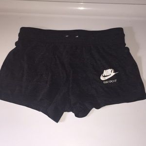 Dark gray loose Nike shorts. (Kids)